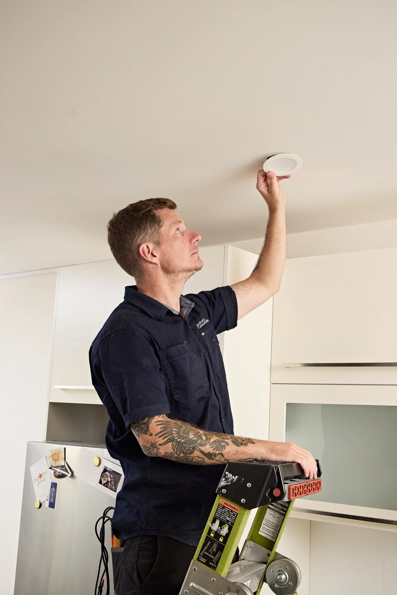Downlight being wired into the ceiling